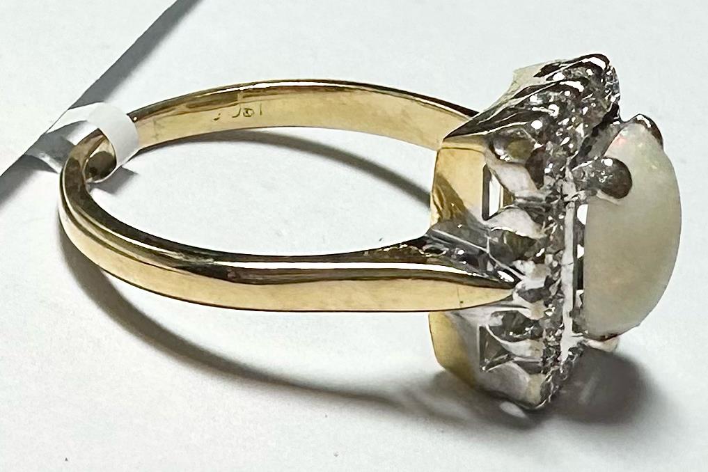 18ct yellow gold opal and diamond ring with size N1/2, featuring vibrant opal and sparkling diamonds on a polished band.