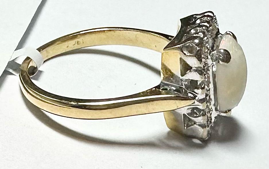 18ct yellow gold ring with opal and diamond accents, size N1/2, featuring a detailed gemstone design.