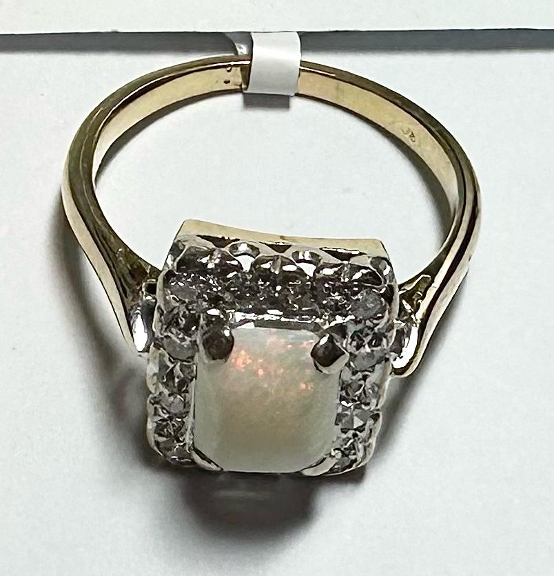 18ct yellow gold opal and diamond ring in size N1/2, featuring a vibrant opal gemstone and sparkling diamonds.