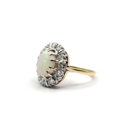 18ct yellow gold oval ring with 1.85ct opal and 0.60ct diamond, featuring a sleek, elegant design.