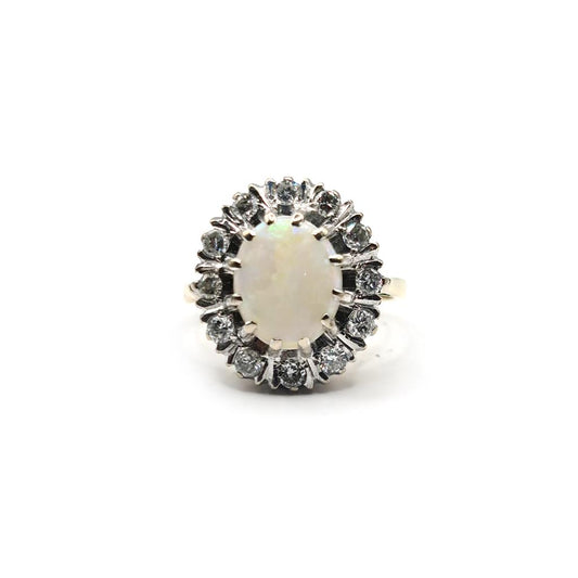 18ct yellow gold oval opal and diamond ring with 1.85 carat opal and 0.60 carat diamonds, showcasing a elegant jewelry design.