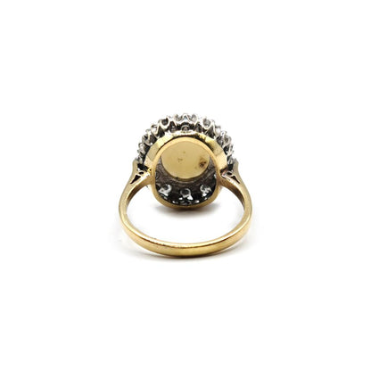 18ct yellow gold oval ring with 1.85 carat opal and 0.60 carat diamond, showcasing elegant jewelry design and craftsmanship.