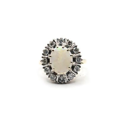 18ct yellow gold oval ring with 1.85 carat opal and 0.60 carat diamond accents, showcasing a vibrant, colorful gemstone design.