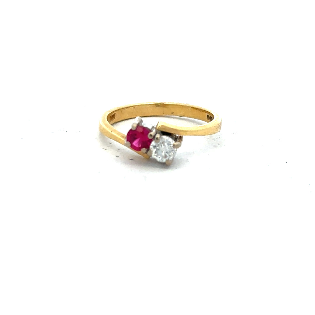 18ct yellow gold ruby and diamond ring in size L, featuring a vibrant ruby centerpiece and sparkling diamonds.