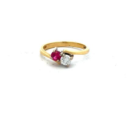 18ct yellow gold ruby and diamond ring in size L, featuring a vibrant ruby centerpiece and sparkling diamonds.