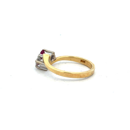 18ct yellow gold ruby and diamond ring, size L, featuring a central ruby and surrounding diamonds in an elegant design.
