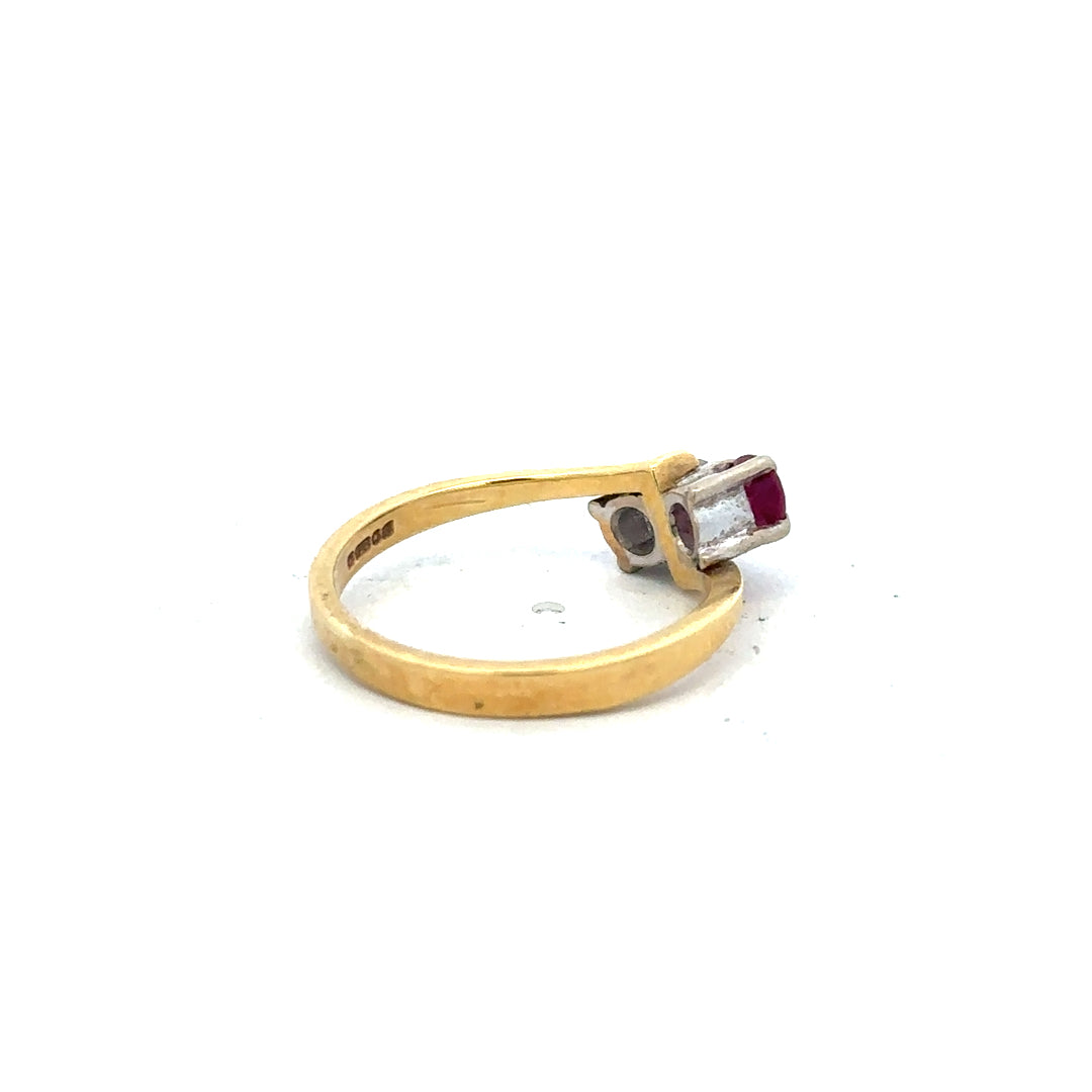 18ct yellow gold ruby and diamond ring in size L, featuring a central ruby surrounded by sparkling diamonds.
