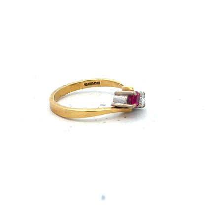 18ct yellow gold ruby and diamond ring in size L, featuring a central ruby surrounded by sparkling diamonds.