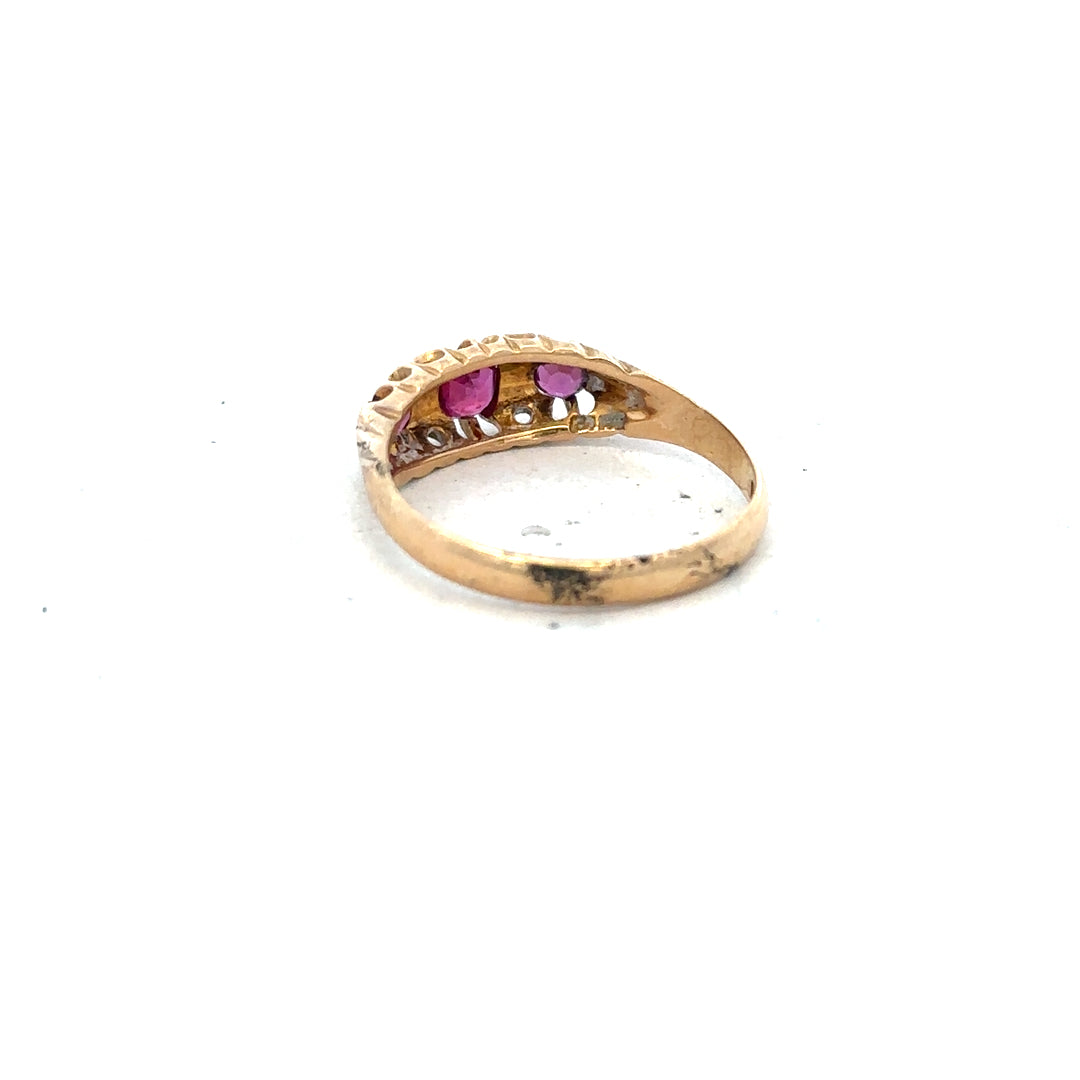 18ct yellow gold ruby and diamond ring, size P, featuring a central ruby surrounded by diamonds on an elegant band.