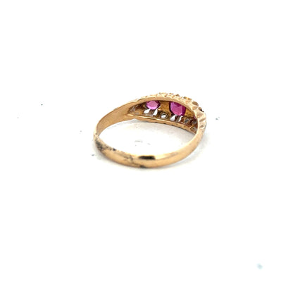 18ct yellow gold ruby and diamond ring in size P, showcasing a central ruby with surrounding diamonds on a sleek band.