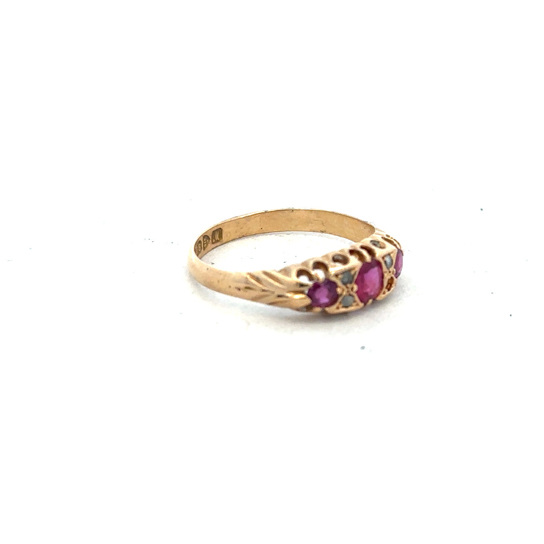 18ct yellow gold ruby and diamond ring, size P, featuring a central ruby with sparkling diamonds in an elegant design.
