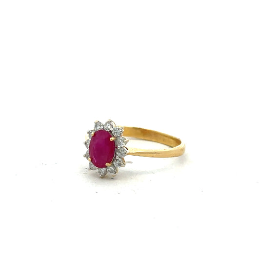 18ct yellow gold ruby and diamond ring in size P with a detailed view of the gemstone setting and elegant band design.