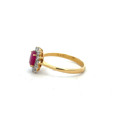 18ct yellow gold ruby and diamond ring, size P, featuring a central ruby surrounded by sparkling diamonds.