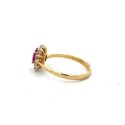 18ct yellow gold ruby and diamond ring in size P, featuring a central ruby surrounded by sparkling diamonds.