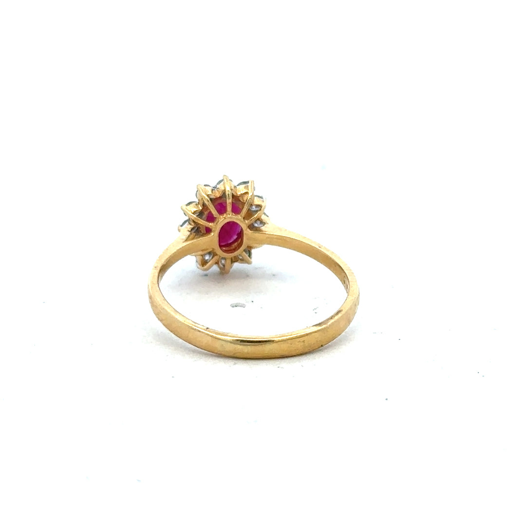 18ct yellow gold ruby and diamond ring in size P, featuring a central ruby gemstone and sparkling diamonds.