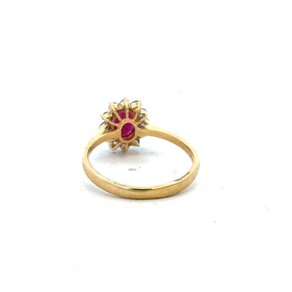 18ct yellow gold ruby and diamond ring in size P, featuring a central ruby gemstone and sparkling diamonds.
