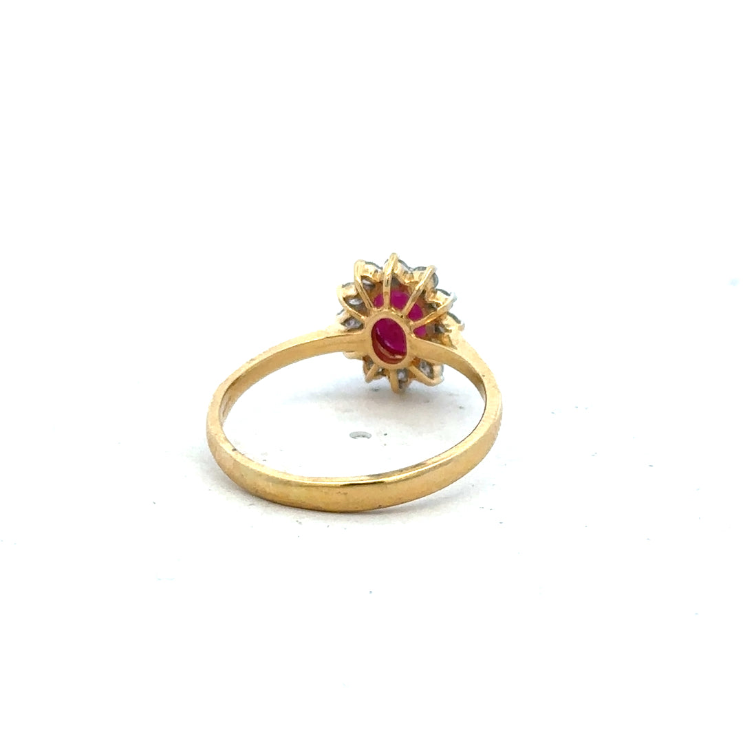 18ct yellow gold ruby and diamond ring in size P, featuring a central ruby surrounded by sparkling diamonds.