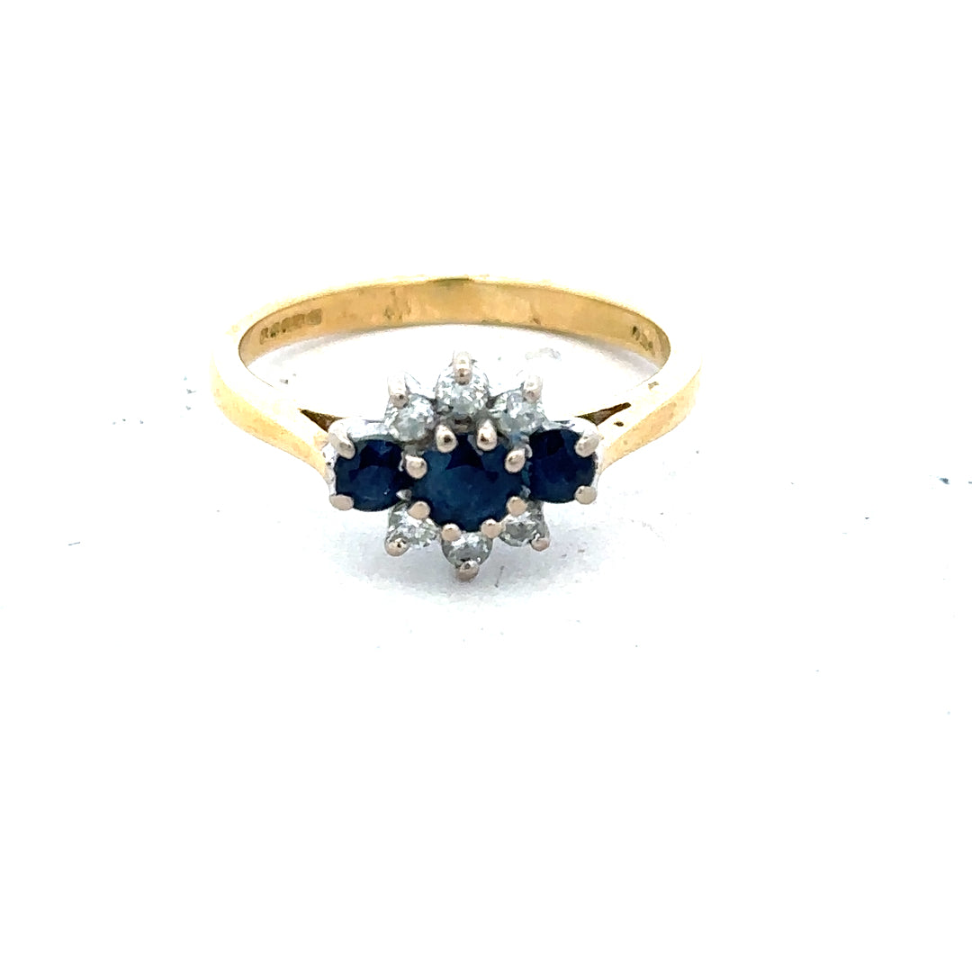 18ct yellow gold sapphire and diamond ring in size K, featuring a central sapphire surrounded by sparkling diamonds.
