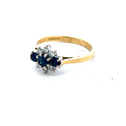 18ct yellow gold sapphire and diamond ring in size K, featuring a central sapphire surrounded by sparkling diamonds.