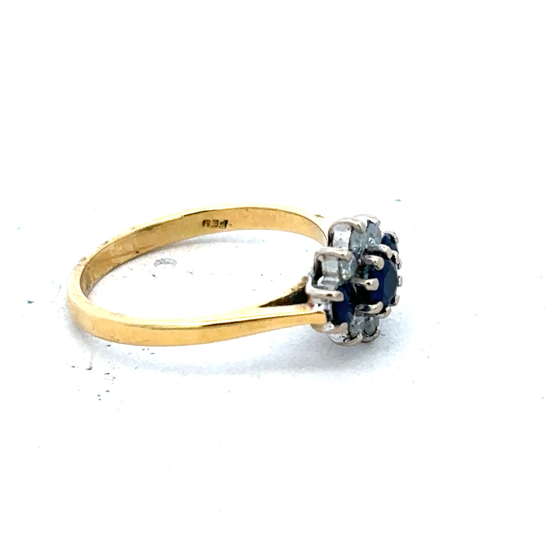 18ct yellow gold sapphire and diamond ring, size K, featuring a sparkling blue sapphire centerpiece and surrounding diamonds.