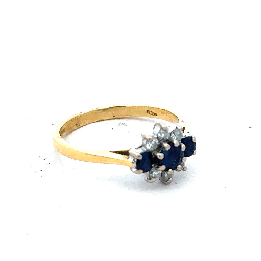 18ct yellow gold sapphire and diamond ring in size K, featuring a vibrant blue sapphire centerpiece with sparkling diamonds.