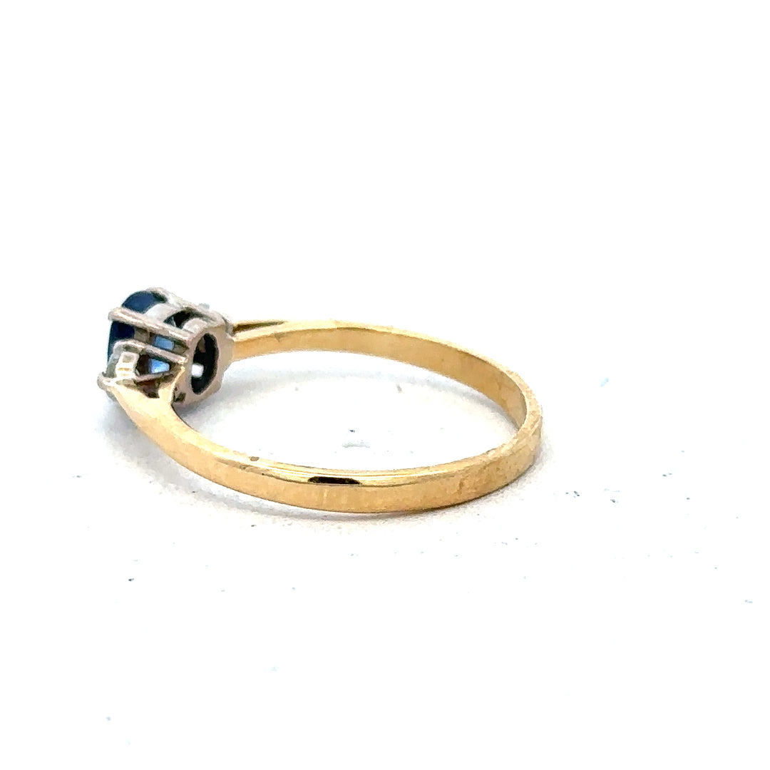18ct yellow gold sapphire and diamond ring, size M, featuring a central blue sapphire with surrounding diamonds.