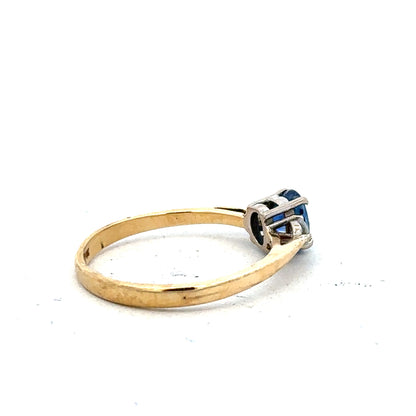 18ct yellow gold sapphire and diamond ring, size M, featuring a central blue sapphire surrounded by sparkling diamonds.