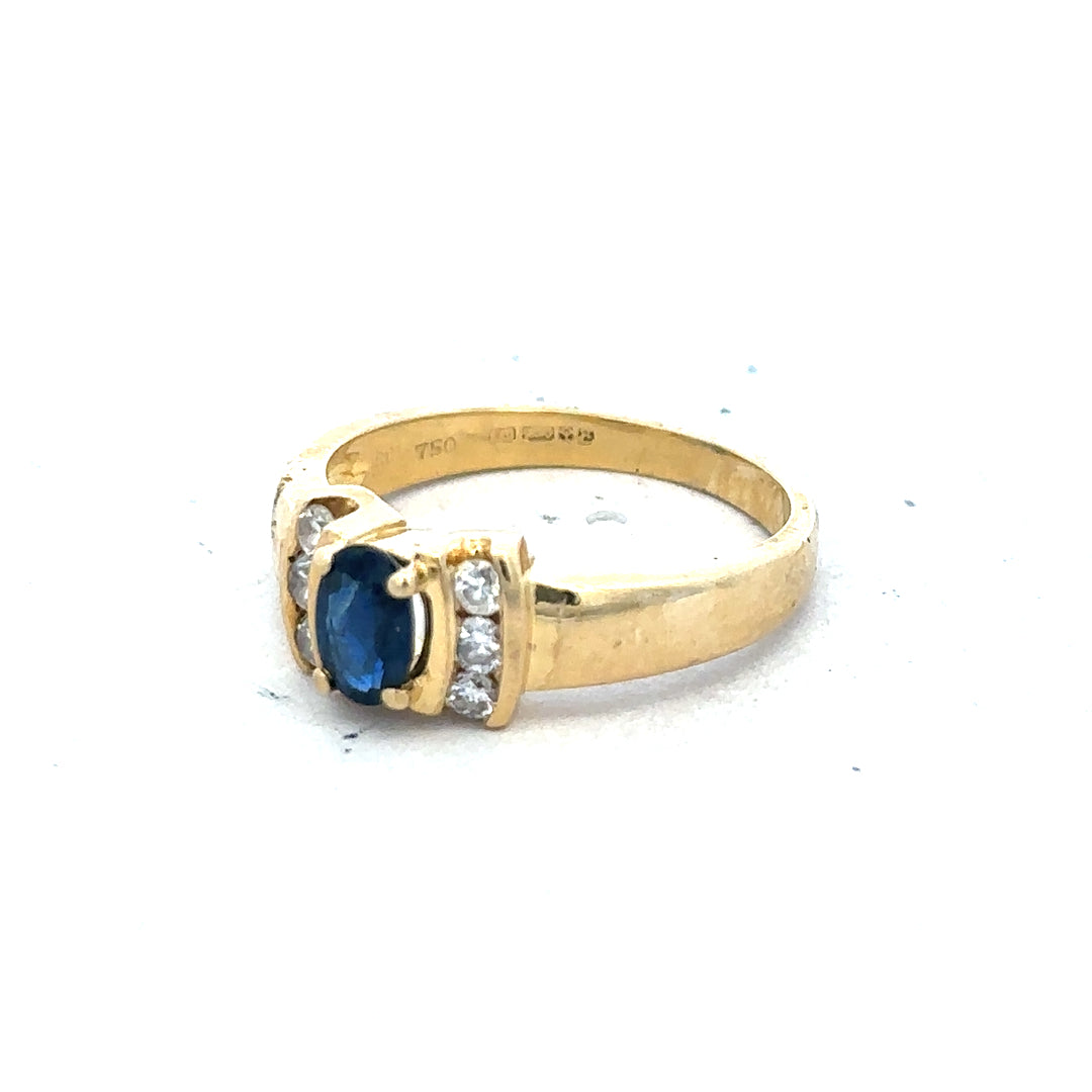 18ct yellow gold sapphire and diamond ring, size M, featuring a vibrant blue sapphire centerpiece with sparkling diamonds.