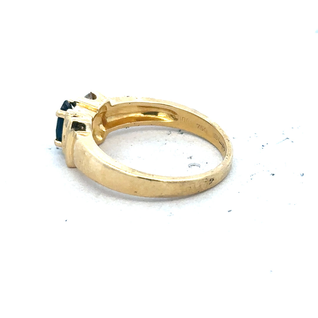 18ct yellow gold sapphire and diamond ring in size M, featuring a central sapphire gemstone surrounded by sparkling diamonds.