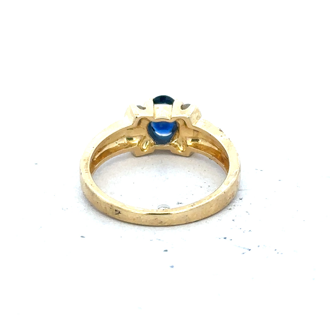 18ct yellow gold sapphire and diamond ring in size M, featuring a vibrant blue sapphire centerpiece with sparkling diamonds.