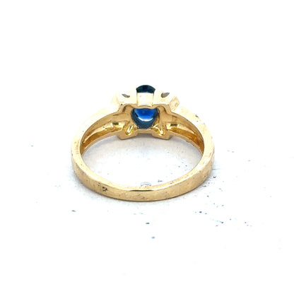18ct yellow gold sapphire and diamond ring in size M, featuring a vibrant blue sapphire centerpiece with sparkling diamonds.