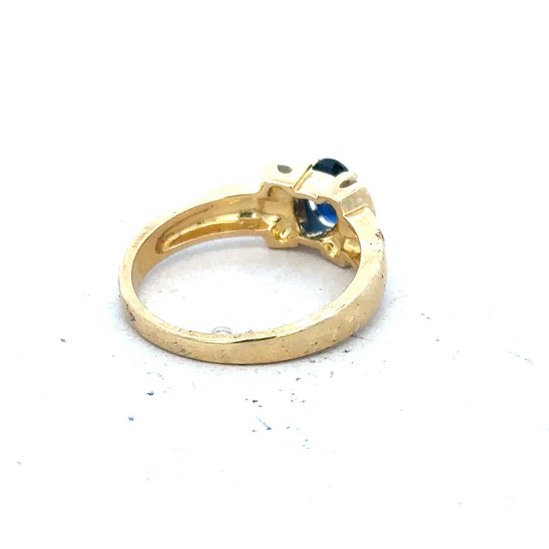 18ct yellow gold sapphire and diamond ring, size M, featuring a central sapphire gemstone surrounded by sparkling diamonds.