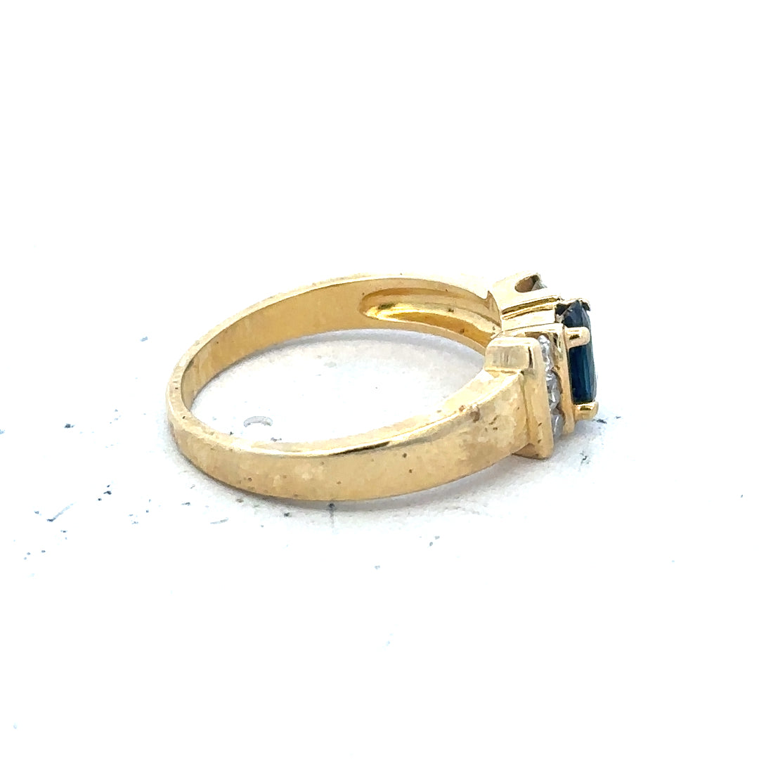 18ct yellow gold sapphire and diamond ring in size M, featuring a vibrant blue sapphire surrounded by sparkling diamonds.