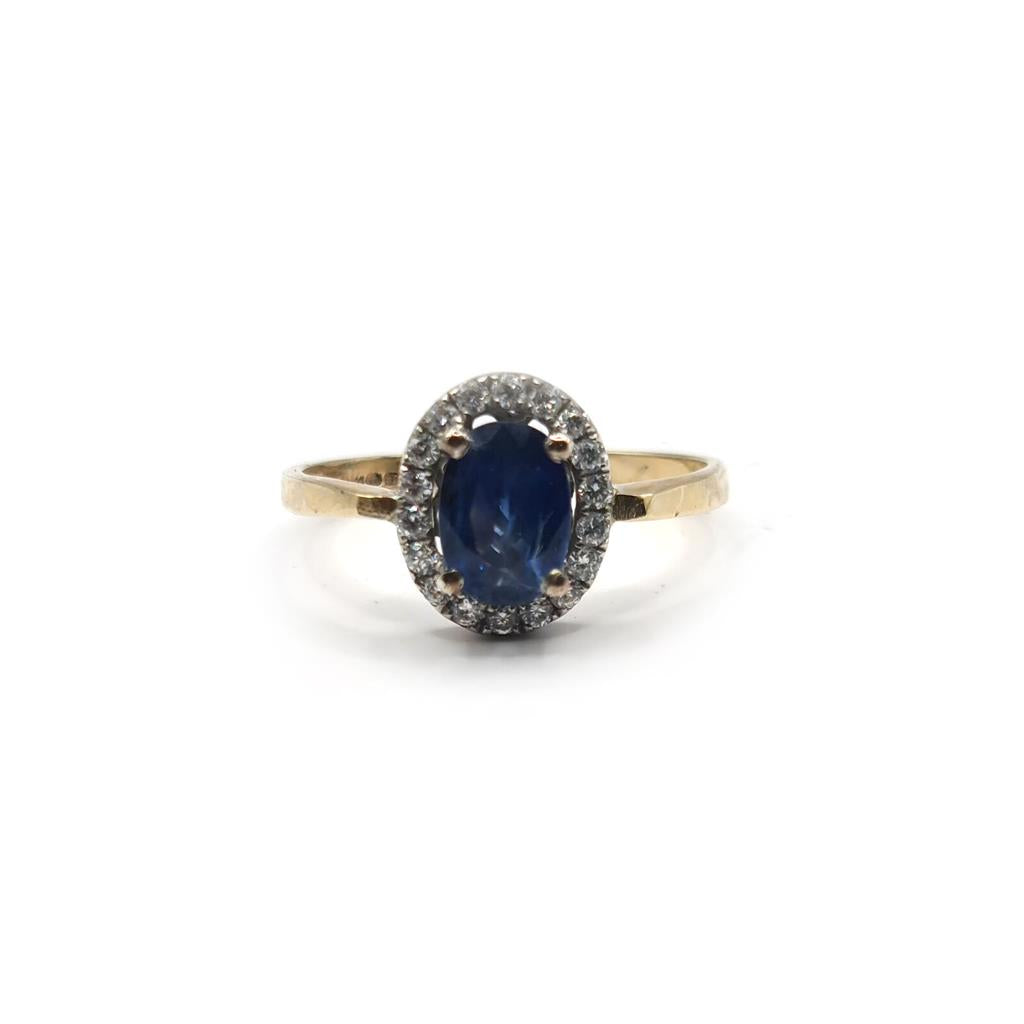 18ct yellow gold sapphire and diamond ring with a central sapphire gemstone and small accent diamonds.