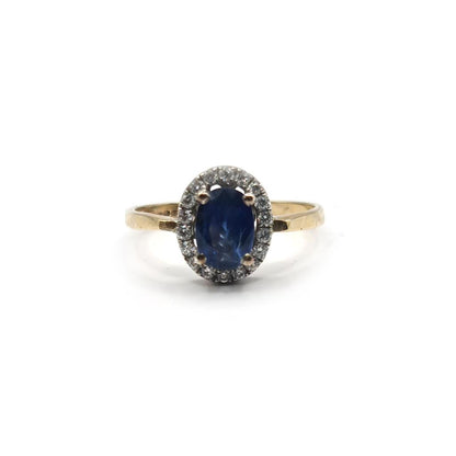 18ct yellow gold sapphire and diamond ring with a central sapphire gemstone and small accent diamonds.