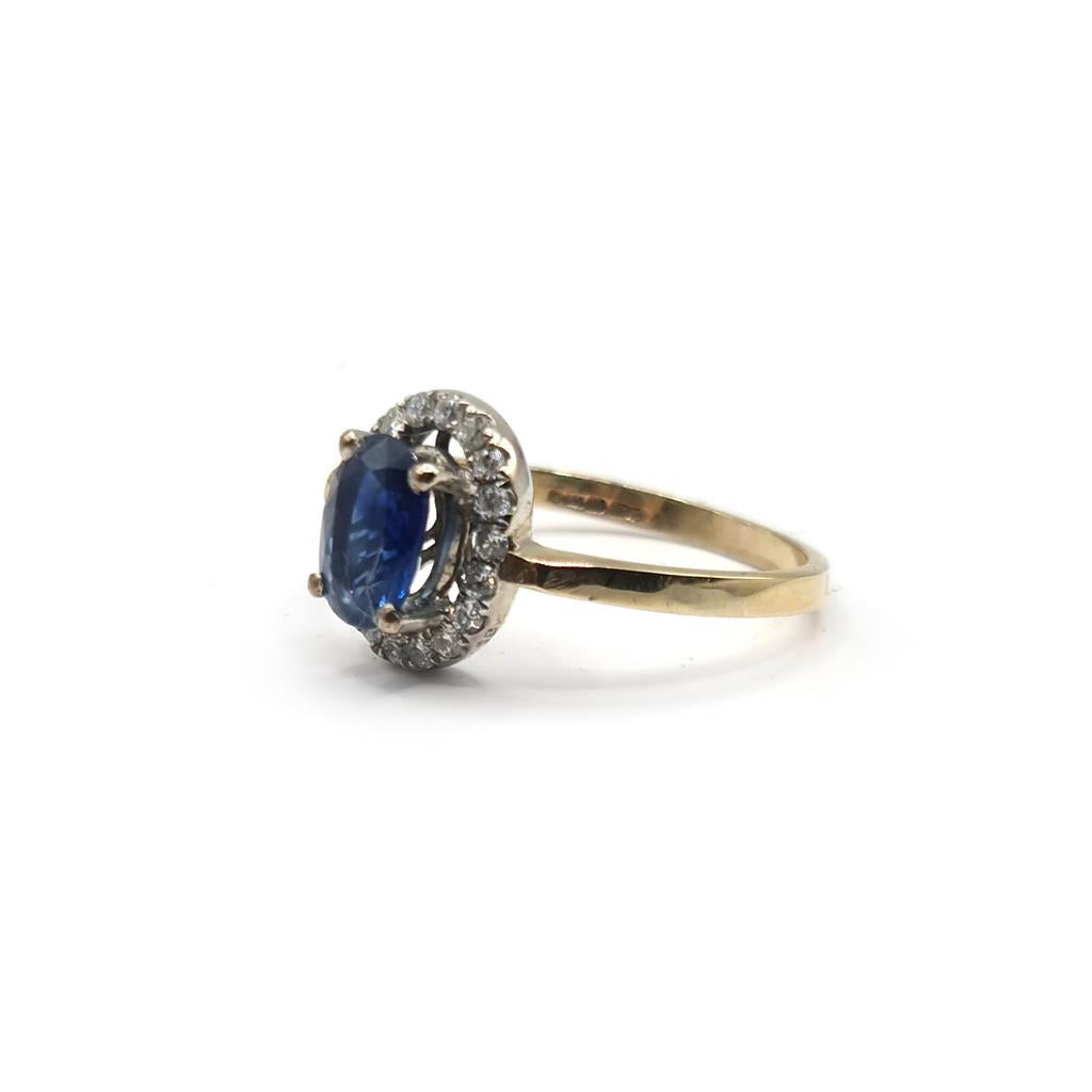 18ct yellow gold sapphire and diamond ring with a central blue sapphire surrounded by sparkling diamonds.