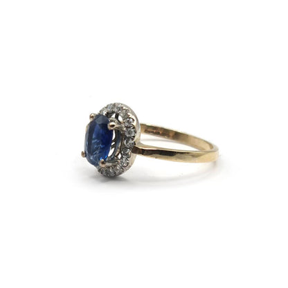 18ct yellow gold sapphire and diamond ring with a central blue sapphire surrounded by sparkling diamonds.