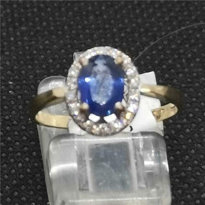 18ct yellow gold sapphire and diamond ring featuring a central blue sapphire and sparkling diamonds in a fine jewelry design.