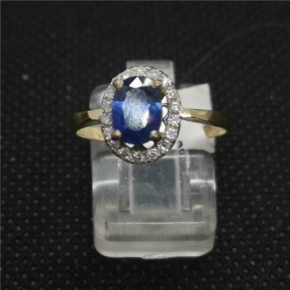 18ct yellow gold ring featuring a central sapphire gemstone surrounded by sparkling diamonds.