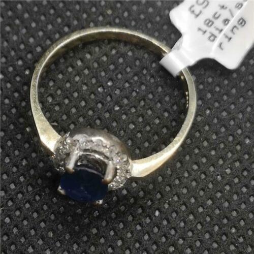18ct yellow gold sapphire and diamond ring with a central blue sapphire surrounded by small diamonds, elegant jewelry piece.