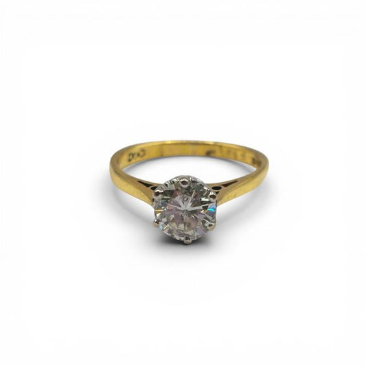 18ct yellow gold single diamond ring with a sparkling central diamond, showcasing elegant jewelry design.