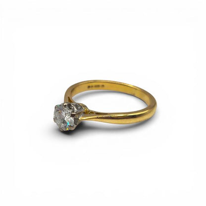 18ct yellow gold diamond ring with a single sparkling stone, featuring a sleek design and elegant craftsmanship.