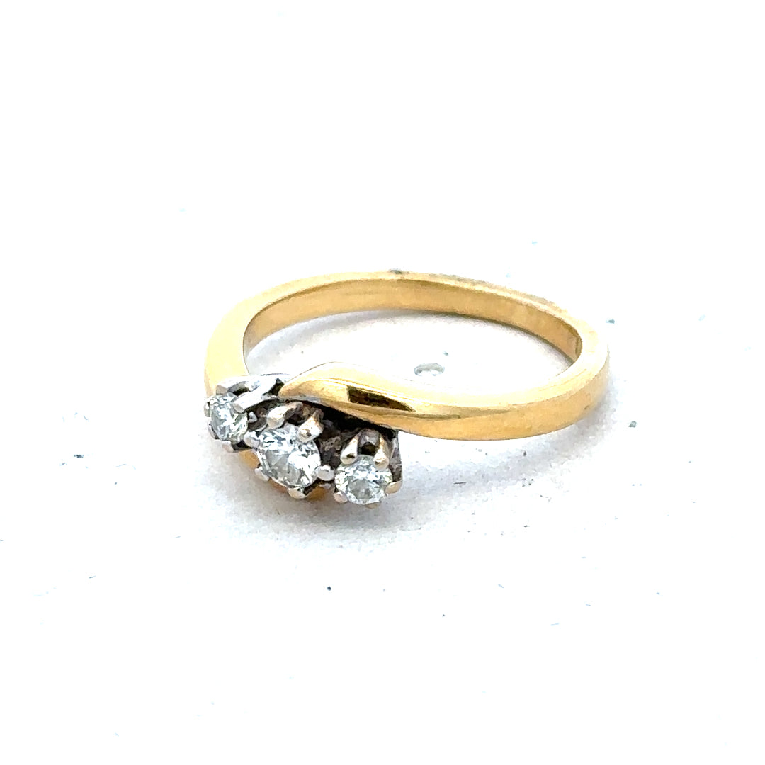 18ct yellow gold three-diamond ring featuring a sleek band and sparkling diamonds, showcasing elegant jewelry craftsmanship.