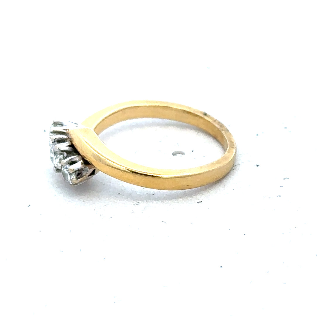 18ct yellow gold three diamond ring with a smooth band and sparkling diamonds, showcasing elegant jewelry design.