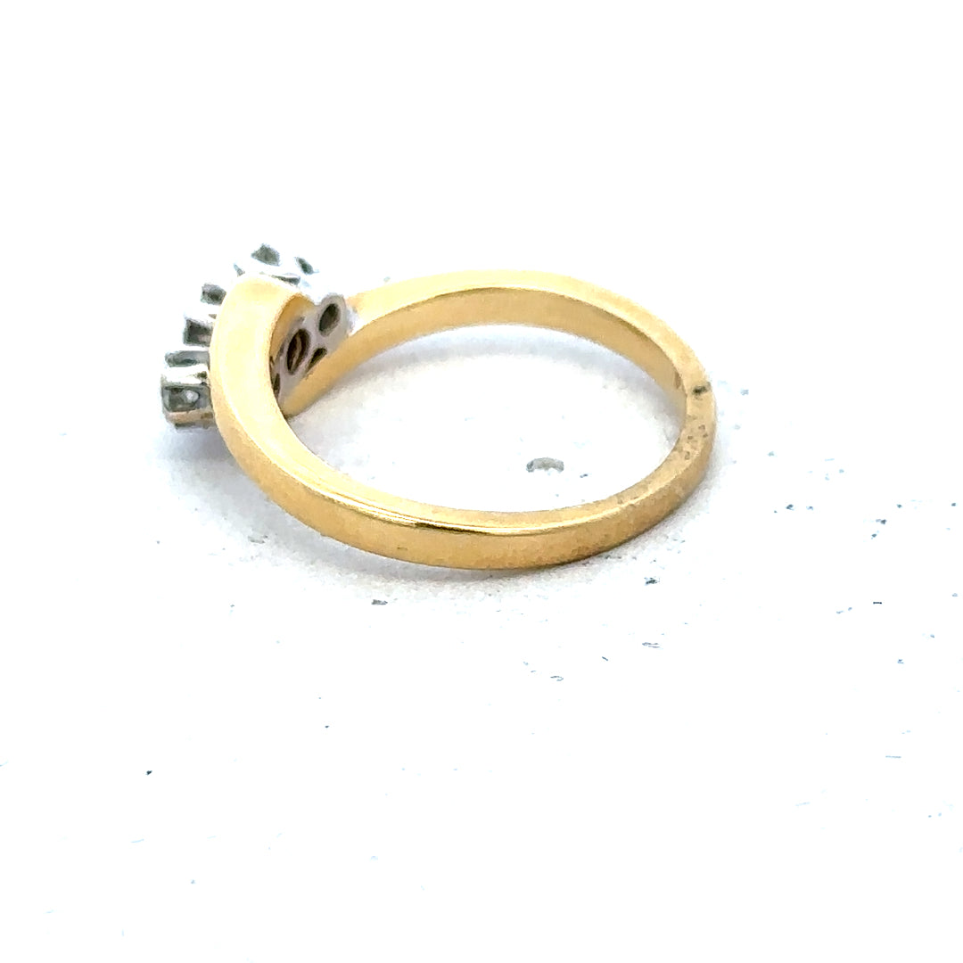 18ct yellow gold three-diamond ring with a sleek band and sparkling stones, showcasing elegant jewelry craftsmanship.