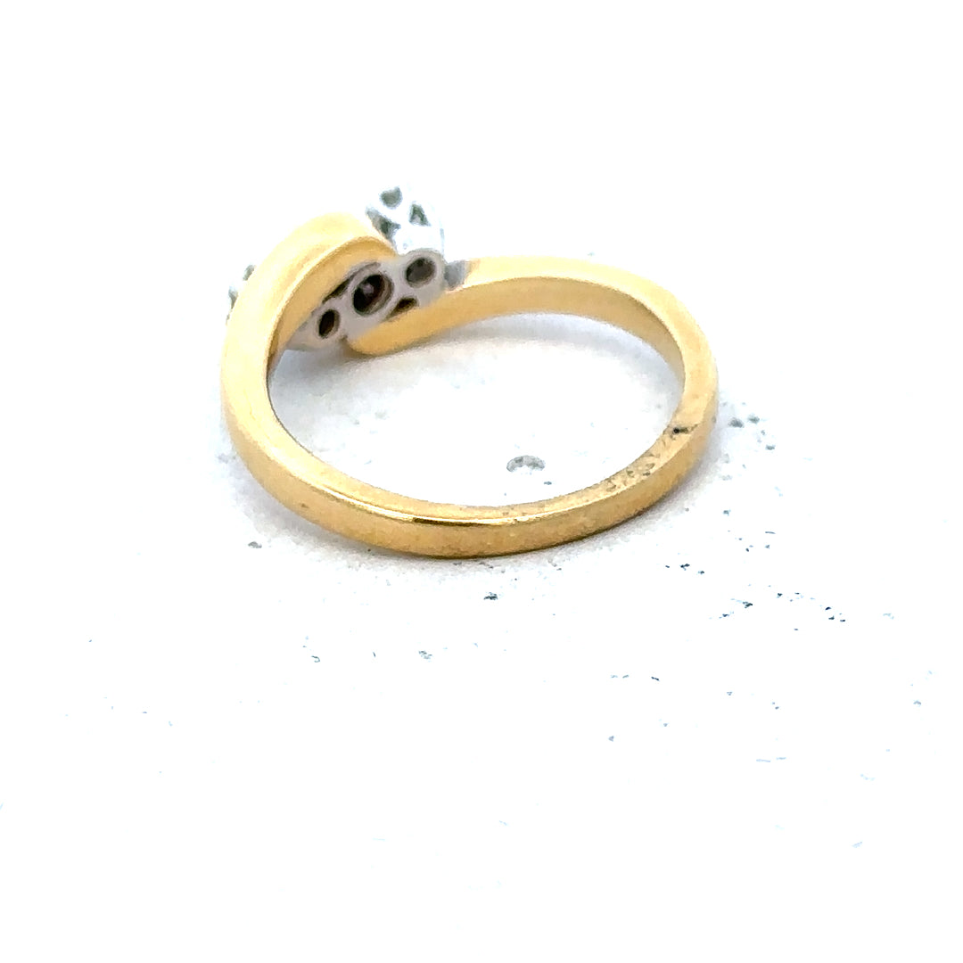 18ct yellow gold three diamond ring with a sleek band and sparkling diamonds, showcasing elegant jewelry design.