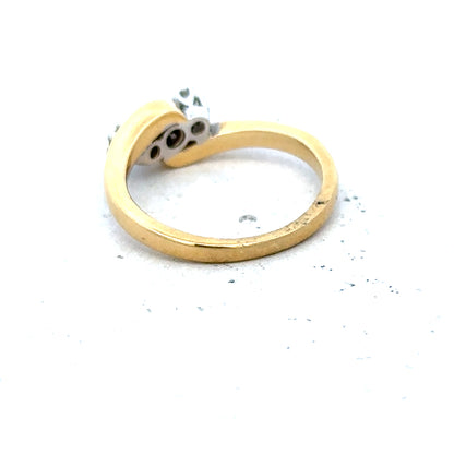 18ct yellow gold three diamond ring with a sleek band and sparkling diamonds, showcasing elegant jewelry design.