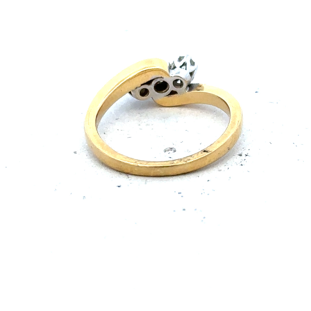 18ct yellow gold three diamond ring with a simple, elegant design, showcasing sparkling diamonds on a polished gold band.