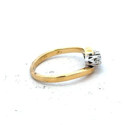 18ct yellow gold three-diamond ring with a sleek band and sparkling stones, showcasing elegant jewelry craftsmanship.