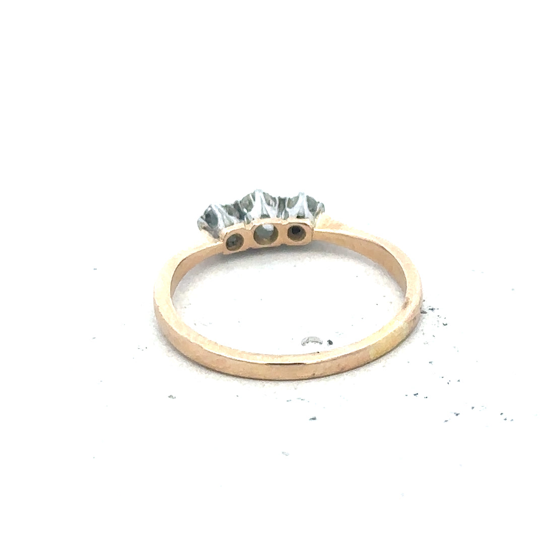 18ct yellow gold three diamond ring with a sleek band and sparkling diamonds, showcasing elegant jewelry craftsmanship.